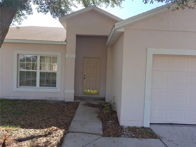 doorway to property with a garage