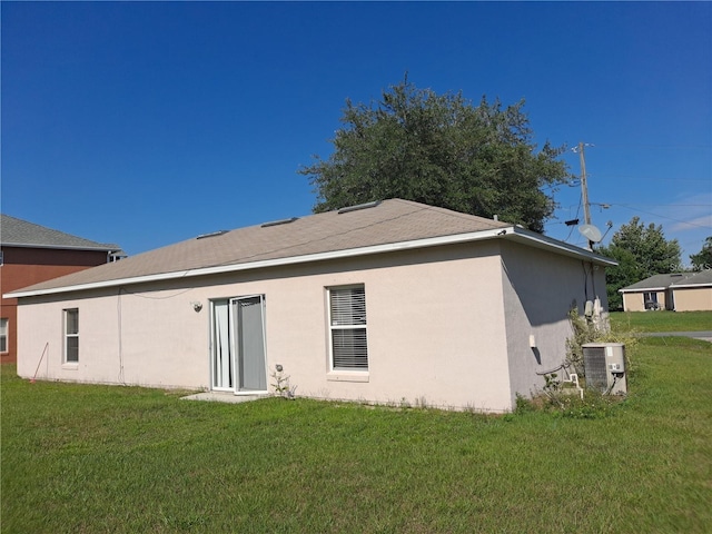 back of property featuring a lawn