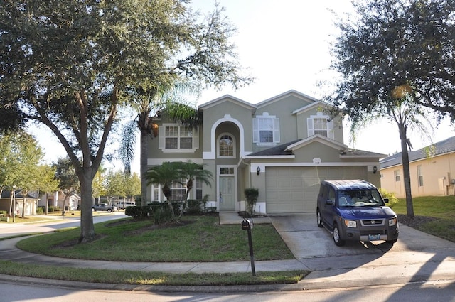 front of property with a garage and a front yard