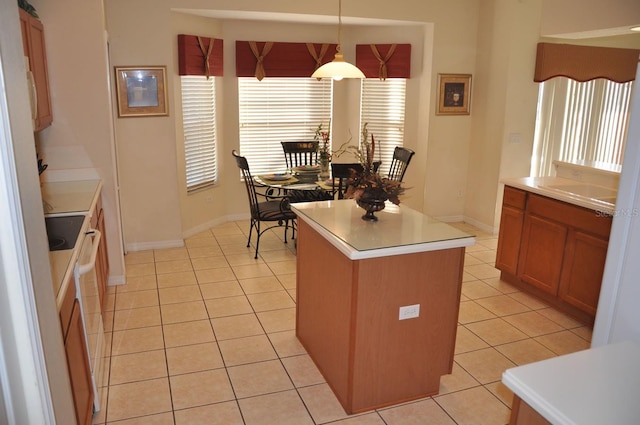 913 Henley Cir, Davenport, FL 33896 - kitchen with white range with electric cooktop, hanging light fixtures, light tile patterned floors, and a kitchen island
