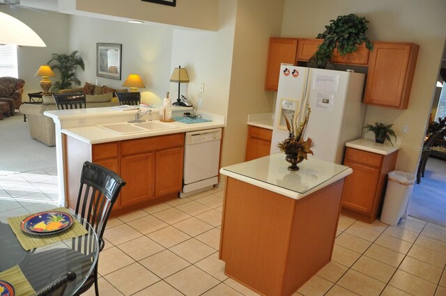 913 Henley Cir, Davenport, FL 33896 - kitchen with light tile patterned flooring, a center island, sink, and white appliances