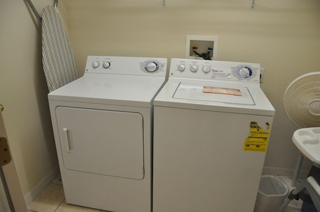 913 Henley Cir, Davenport, FL 33896 - laundry room featuring washer and clothes dryer and light tile patterned flooring