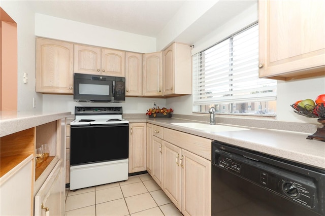 626 Orange Dr Unit 242, Altamonte Springs, FL 32701 - kitchen with light tile patterned flooring, sink, light brown cabinets, and black appliances