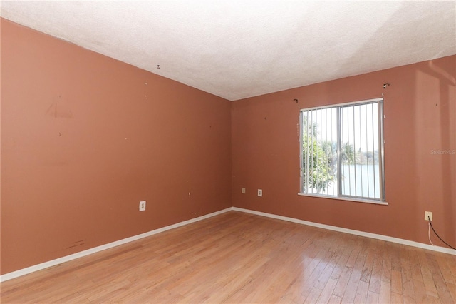 626 Orange Dr Unit 242, Altamonte Springs, FL 32701 - empty room featuring hardwood / wood-style flooring and a textured ceiling
