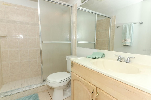 626 Orange Dr Unit 242, Altamonte Springs, FL 32701 - bathroom featuring vanity, tile patterned flooring, a shower with shower door, and toilet