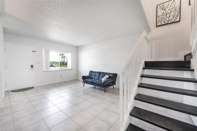 tiled foyer entrance featuring a textured ceiling