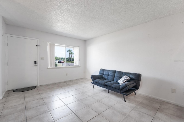 sitting room featuring light tile patterned flooring and a textured ceiling