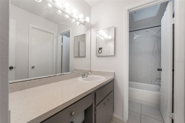 bathroom featuring vanity, tiled shower / bath combo, and tile patterned flooring