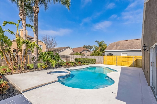 view of swimming pool with a patio and an in ground hot tub