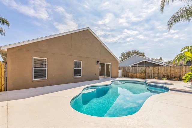 view of swimming pool with a patio area and an in ground hot tub