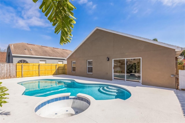 view of swimming pool with an in ground hot tub and a patio area