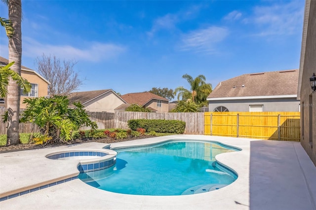 view of pool with a patio and an in ground hot tub