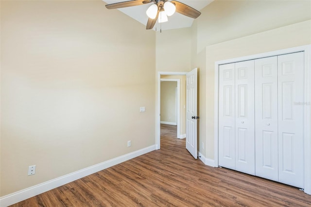 unfurnished bedroom with hardwood / wood-style flooring, a closet, and ceiling fan