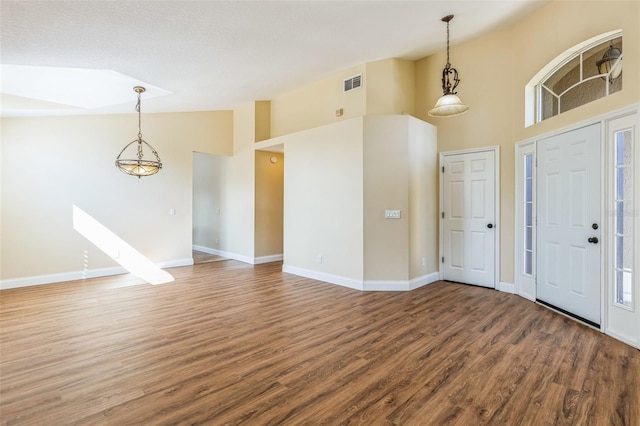 entrance foyer featuring hardwood / wood-style flooring and high vaulted ceiling