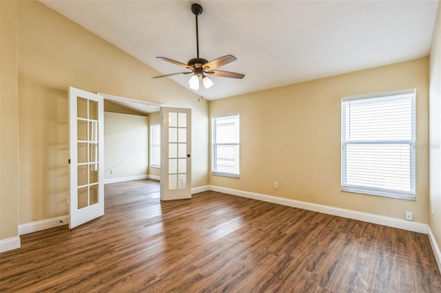 spare room featuring lofted ceiling, dark wood-type flooring, ceiling fan, and french doors