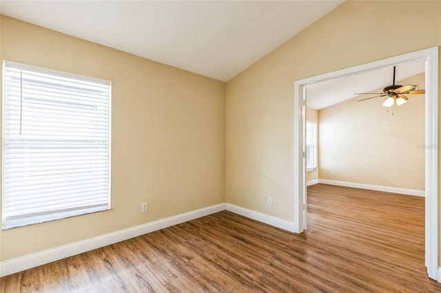 empty room featuring ceiling fan, vaulted ceiling, and hardwood / wood-style floors