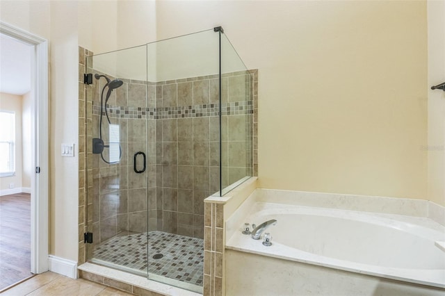 bathroom with shower with separate bathtub