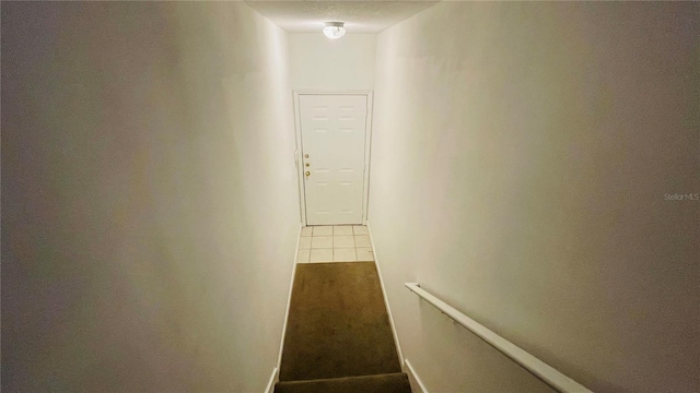 hallway with tile patterned flooring