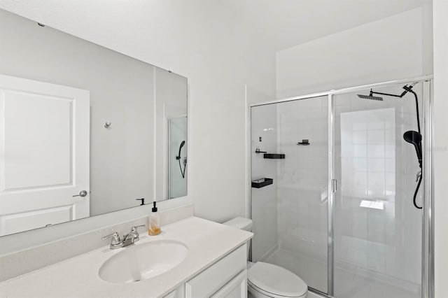 bathroom featuring toilet, vanity, and an enclosed shower