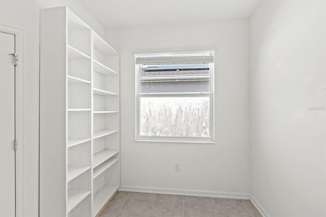 spacious closet featuring light tile patterned floors