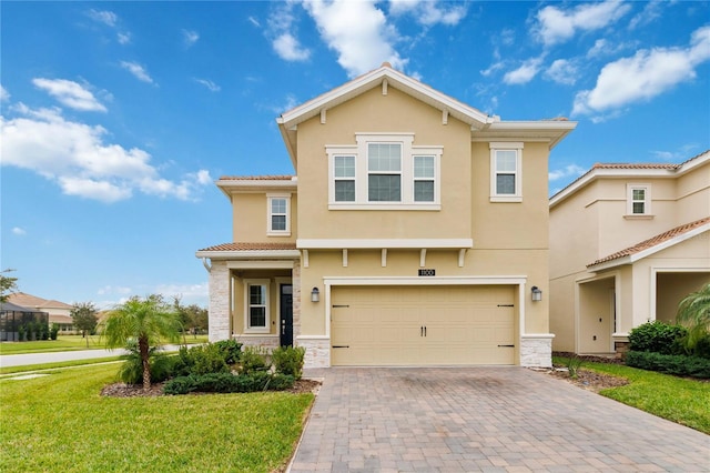 view of front of house with a garage and a front lawn