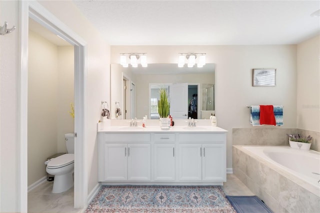 bathroom with toilet, tile patterned floors, vanity, and a relaxing tiled tub