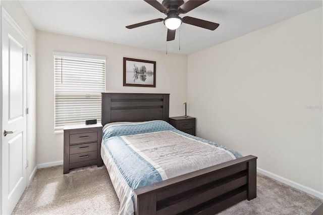 bedroom with ceiling fan and light colored carpet