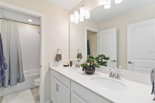 full bathroom with toilet, vanity, and shower / tub combo