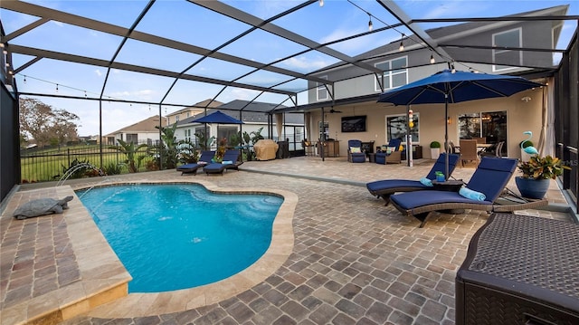 view of pool with a patio, a lanai, a fenced in pool, and fence