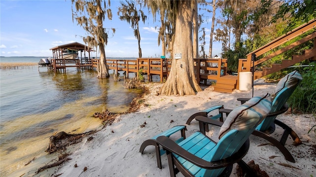 dock area featuring a beach view and a water view