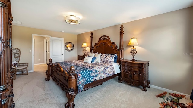 bedroom with baseboards and light colored carpet