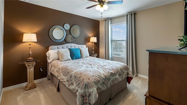 bedroom featuring baseboards, a ceiling fan, and light colored carpet