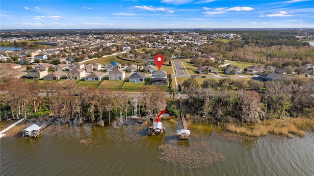 drone / aerial view featuring a water view and a residential view