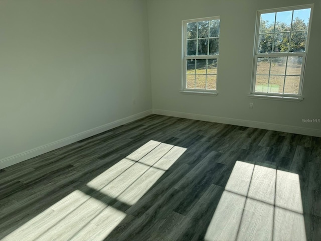 spare room with dark hardwood / wood-style floors