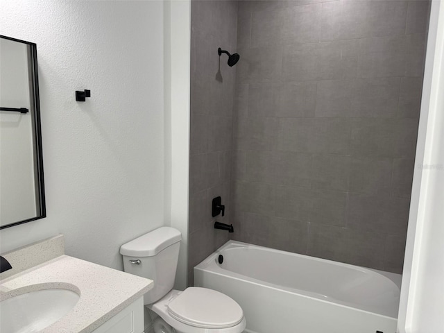 full bathroom with vanity, tiled shower / bath, and toilet