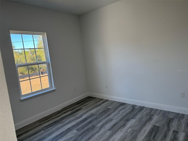 unfurnished room with dark hardwood / wood-style floors