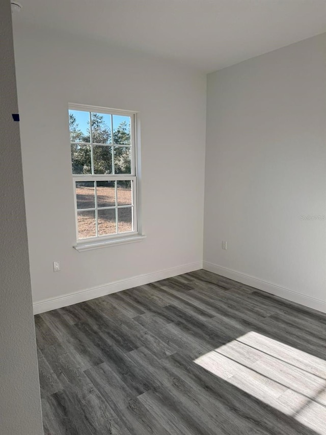 unfurnished room featuring dark hardwood / wood-style floors