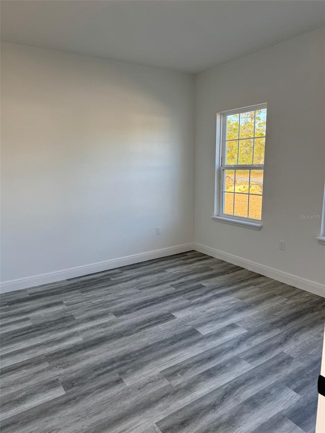 unfurnished room featuring dark hardwood / wood-style floors