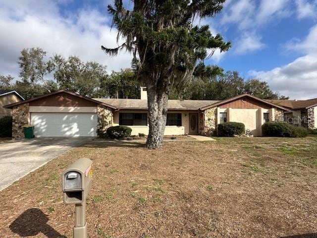 single story home with a garage and a front lawn