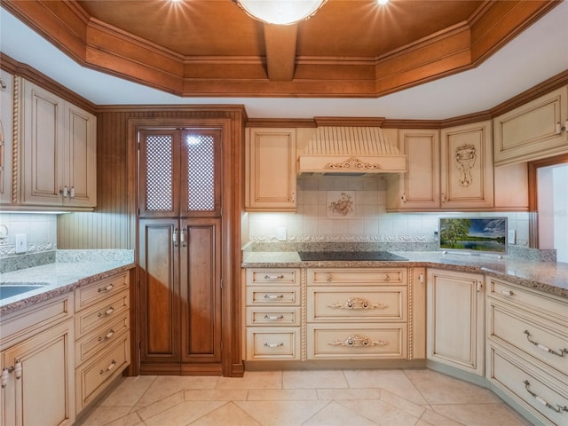 kitchen with black electric stovetop, custom exhaust hood, light stone countertops, and decorative backsplash