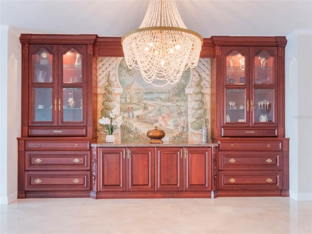 bar with a chandelier, light stone counters, and decorative light fixtures