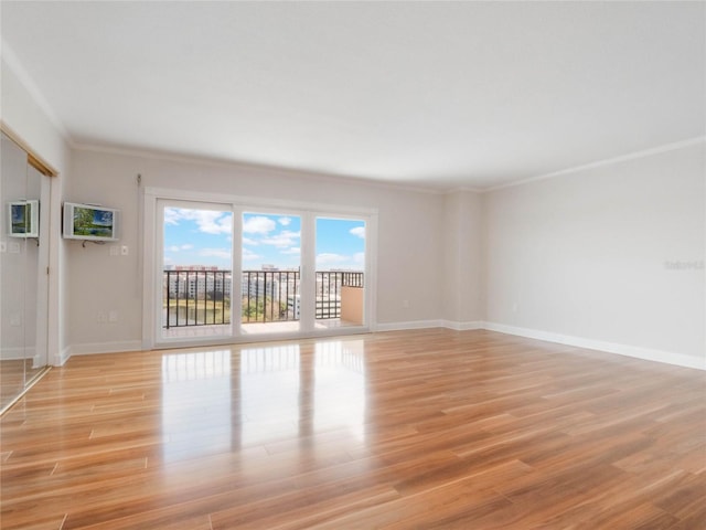 unfurnished room featuring light hardwood / wood-style floors and crown molding