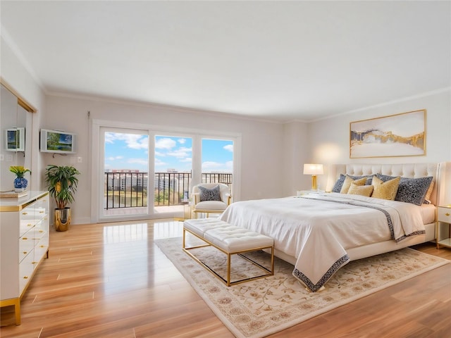 bedroom with light hardwood / wood-style floors, crown molding, and access to exterior