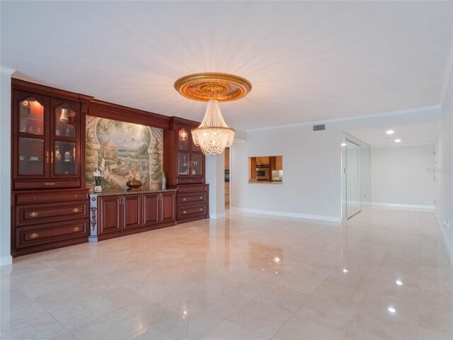 interior space with a chandelier and crown molding