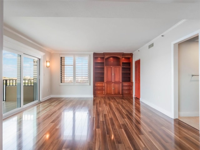 unfurnished living room with dark hardwood / wood-style floors and ornamental molding