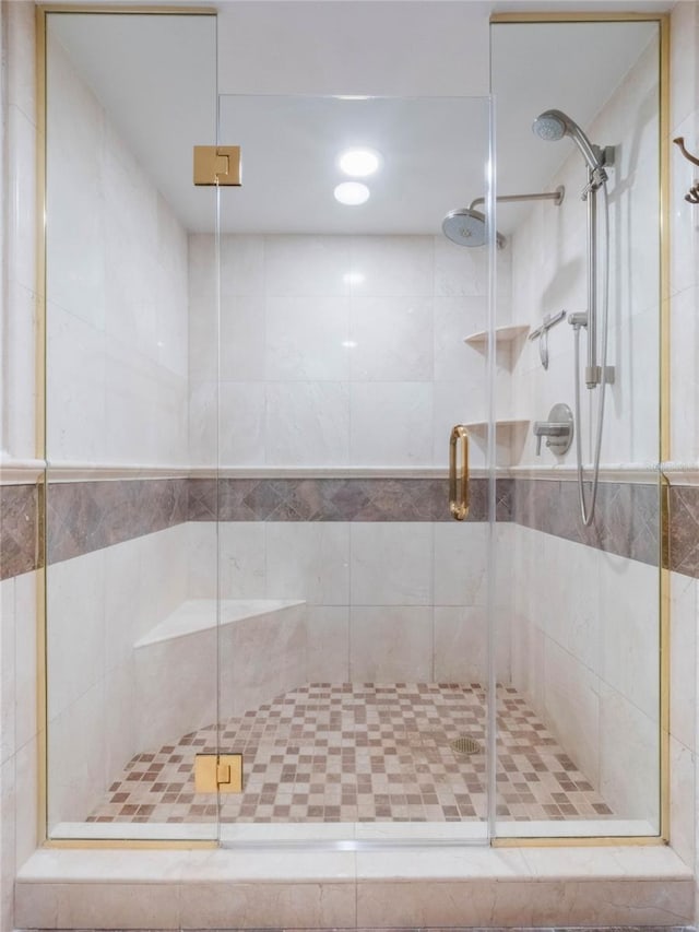 bathroom featuring a shower with door