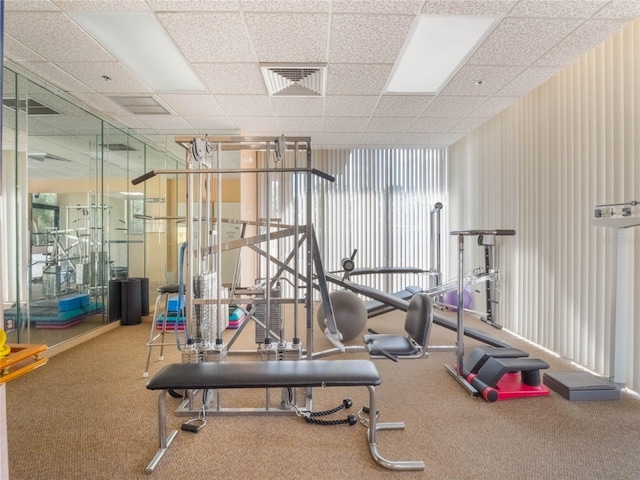 workout area with a paneled ceiling