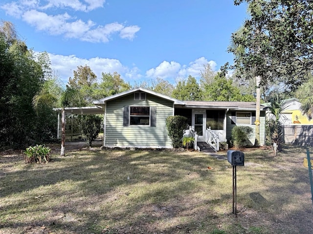 view of front of house featuring a carport and a front lawn