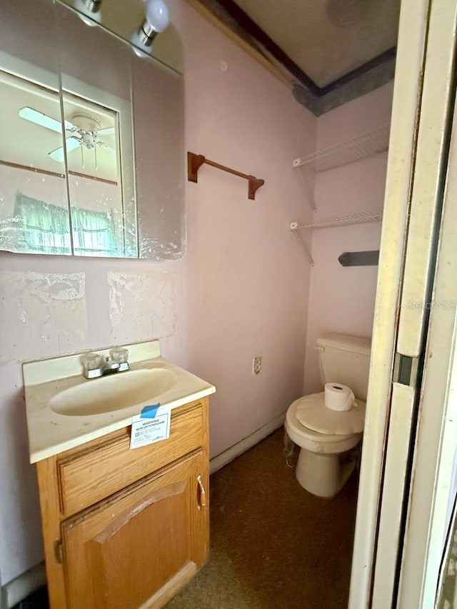 bathroom featuring vanity and toilet