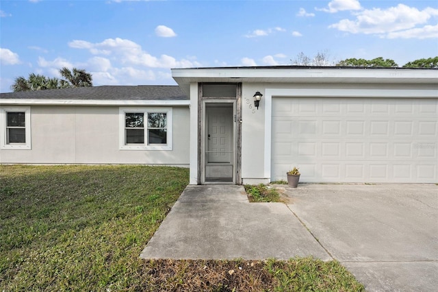 view of front of home featuring a garage and a front lawn